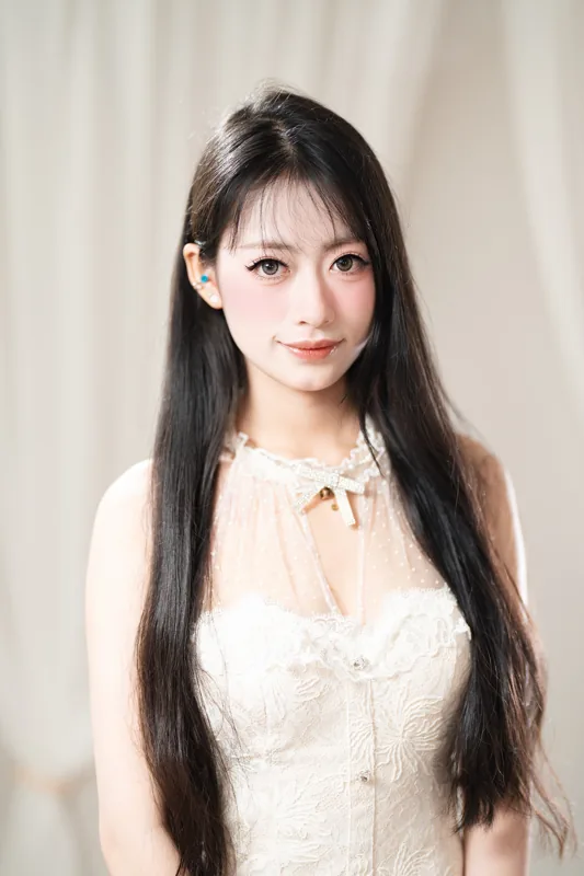 Beauty portrait in warm light, lace top, finished makeup