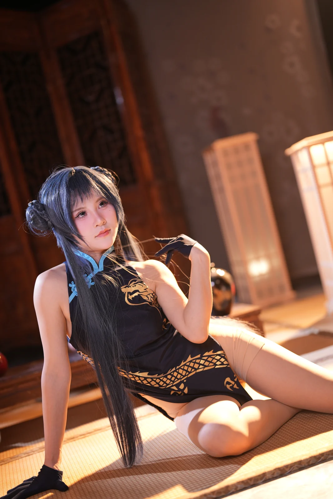 Portrait in a dark qipao inside a lantern-lit traditional room
